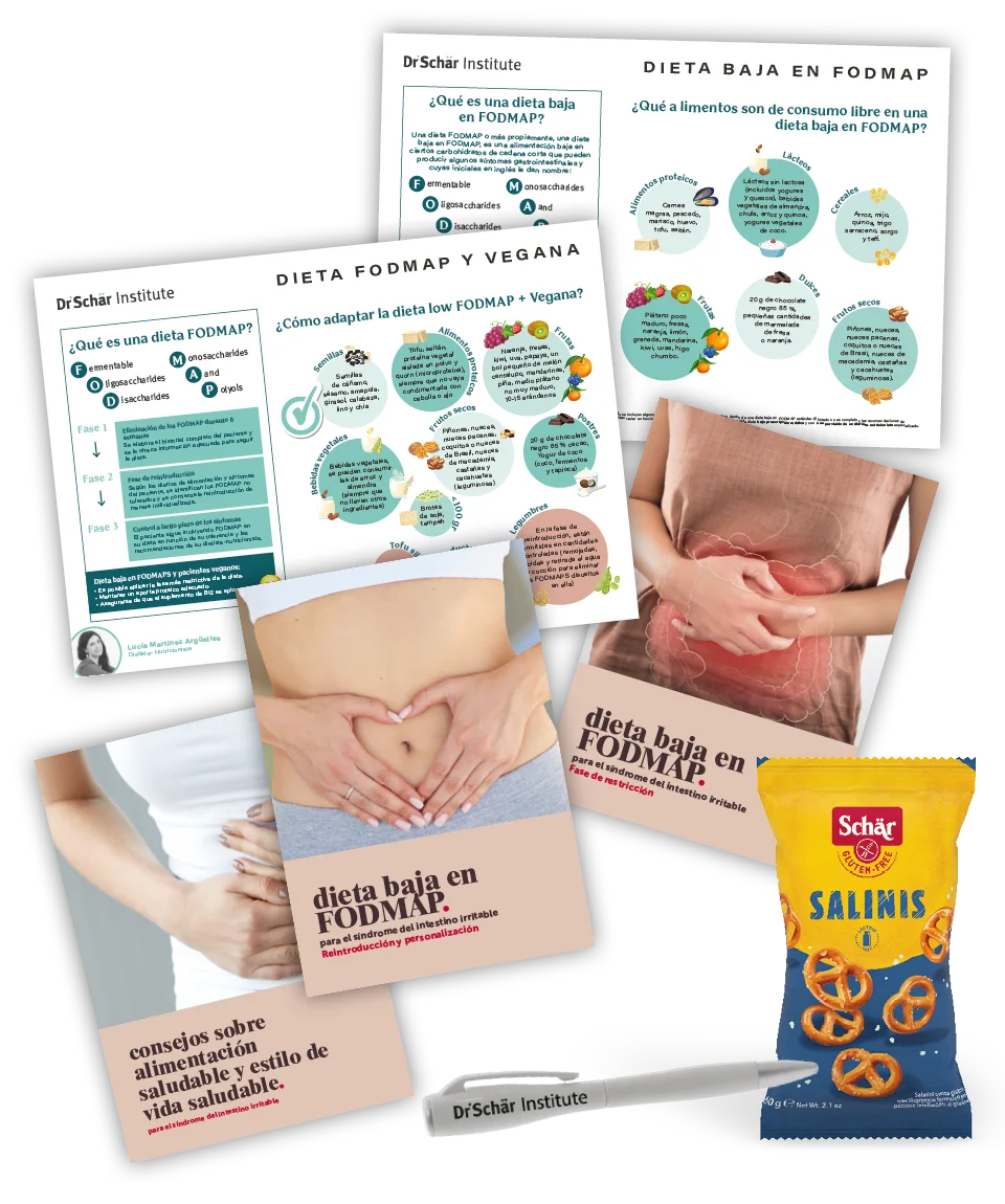 Folletos sobre una dieta baja en FODMAP, manos en el estómago y un paquete de pretzels sin gluten