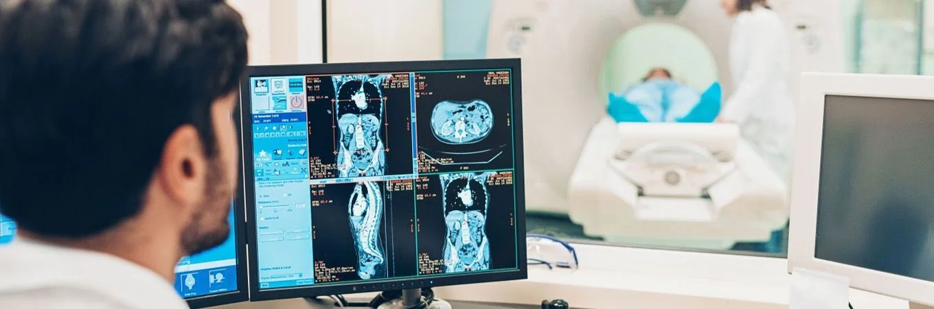 a doctor looking at an MRI scan on a screen